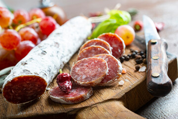 salami with spice on board, salami and fresh grape