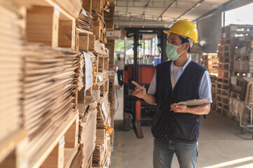 Worker checking raw material inventory in  factory