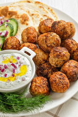 Keftedakia, fried greek meatballs on white platter