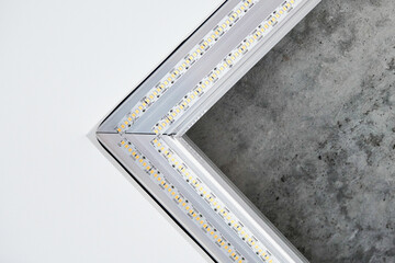 Strip LED light with square aluminum profile on stretch ceiling, close up. Home renovation concept