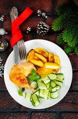 Roast chicken on a plate. Christmas background