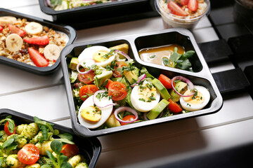 Diet box with egg and avocado salad, appetizing take-away meal.
Appetizing ready-to-go dish served...