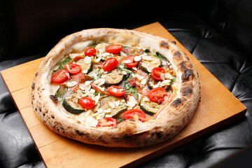 Pizza with eggplant, spinach and tomatoes.
A tasty dish.Culinary photography. Suggestion to serve the dish.