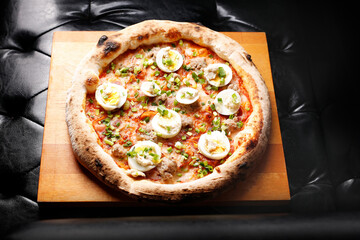 Pizza with bacon, egg, and green chives.
A tasty dish.Culinary photography. Suggestion to serve the dish.