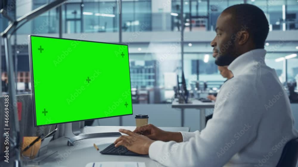 Poster Diverse Modern Office: Handsome Black IT Technician Using Desktop Computer with Green Chroma Key Screen. Engineer Administrator Work on e-Commerce Development, Project Marketing, Big Data Analysis