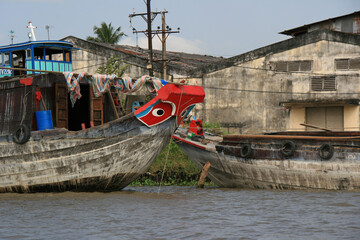 boat and warehouses along the mekong delta in vietnam