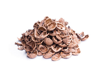 Pile of empty broken walnut shells isolated on white