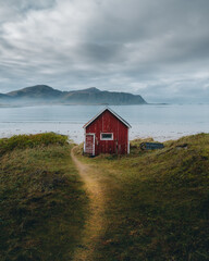 A typical red and colorful cottage of the Norwegian culture and architecture in Norway . High quality photo - obrazy, fototapety, plakaty
