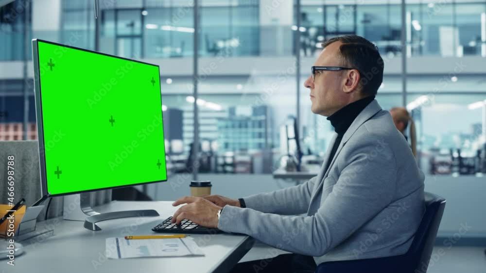 Leinwandbilder Diverse Corporate Office: Stylish Handsome Big Data Engineer Using Desktop Computer with Green Chroma Key Screen. Businessman Working on e-Commerce Project Marketing, Development. Static Medium Shot