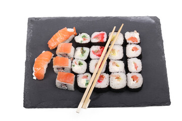 on a white background. the black stone on it is pieces of seafood, sushi. close-up. Asian food