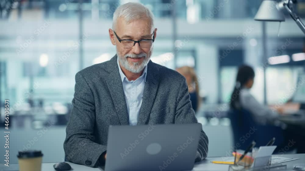 Aufkleber in office: portrait of successful middle aged corporate businessman working on computer at his desk,