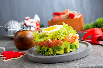 salmon and avocado and cucumber. salad on plate