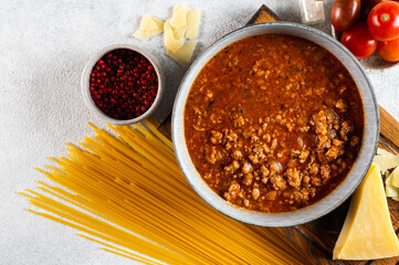 Ingredients for spaghetti bolognese on light background. Raw pasta bolognese. Pasta flatlay. Italian bolognese. Food ingredients. Pasta top view