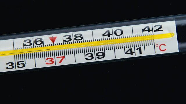 Glass Mercurial Thermometer On A Black Background