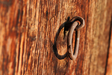 rusty iron doorknob on old wooden door