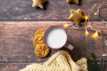 Fototapeta na wymiar a cup of milk with cookies on a wooden background