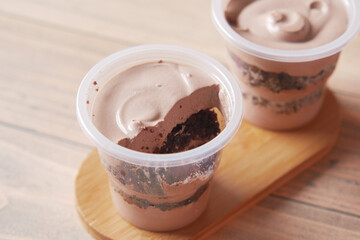 Mousse cake in a container on table 