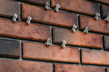 Installing the tiles in the form of brick on the wall using plastic crosses between the tiles.
