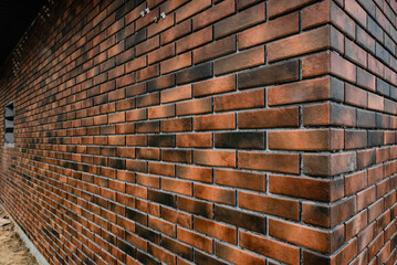 Laying the tiles in the form of brick on the wall outside.