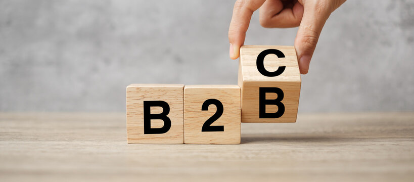 hand change wooden cube block from B2C to B2B. E Commerce, marketing and strategy concepts
