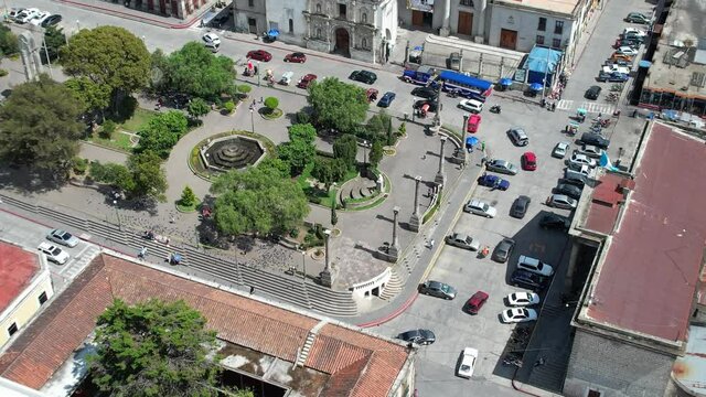 Parque Centro America Centro Historico Quetzaltenango, Xela, Guatemala. Drone footage of Central Park in urban colonial highlands Guatemalan city with normal vehicle and pedestrian traffic. Daylight.