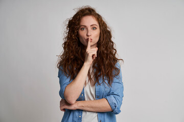 Young woman showing quiet sign