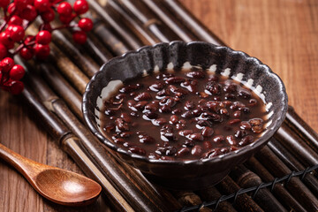 Adzuki red bean soup on wooden table background.