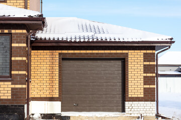 The door to the garage in  brick house.