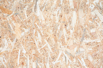 Texture of old pressed wooden OSB panel. Oriented strand board faded in the sun