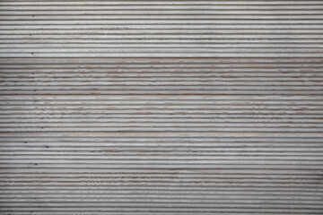 Closeup texture of the larch stripped terrace board. Faded Unpainted grooved wood terrace planks