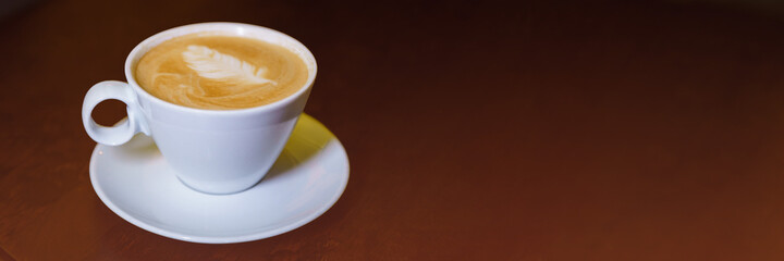 banner cappuccino cup with latte art on top