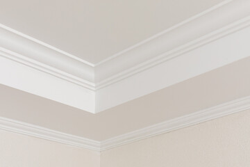 Close-up detail of decoration in interior renovation. Angular ceiling skirting made of classic...