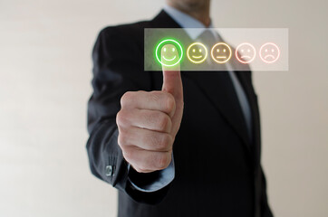 Businessman choosing screen on the happy Smile face icon to give satisfaction in service, Customer service and Satisfaction concept, rating very impressed.
