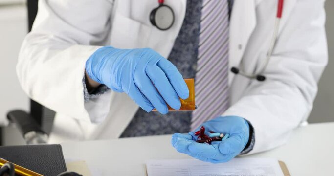 Doctor sitting at table and pouring many capsules from jar into hand 4k movie