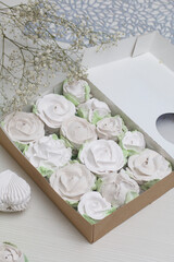 Homemade marshmallows in craft boxes for a gift. Zephyr in the form of roses. Close-up shot.