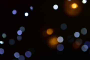 Christmas lights or bokeh in the dark background. Christmas or New Year's atmosphere. Place for...