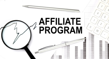 AFFILIATE PROGRAM text on document with pen,graph and magnifier,calculator