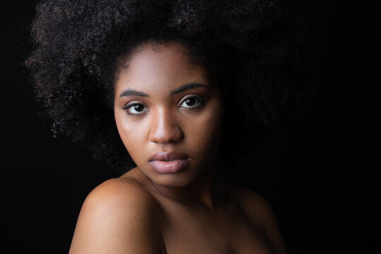 face of cute african woman on black background 