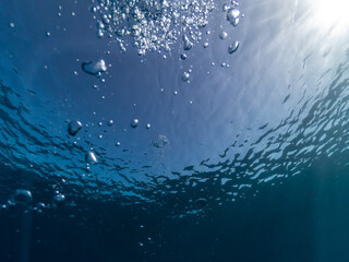 Underwater bubbles in blue sea