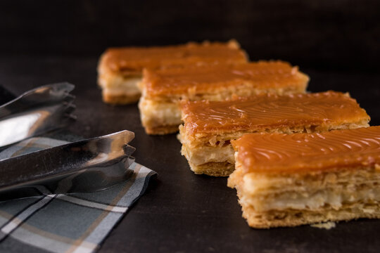 Traditional Colombian dessert Milhojas with tongs