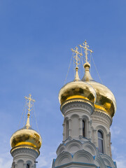 Golden onion domes of white stone orthodox temple of St. Peter and Paul in spa city of Karlovy Vary...