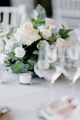 Composition with white roses on a gray table. Wedding decor