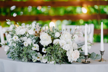 The banquet table is decorated with candles and flower arrangements.