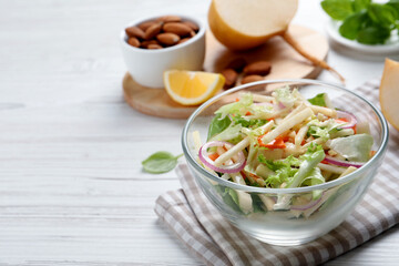 Delicious turnip salad served on white wooden table, space for text