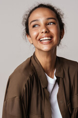 Young hispanic woman in shirt laughing and looking aside