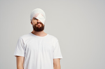 male patient with bandaged head and eye hospitalization isolated background