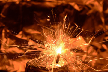 sparklers lit on a foil stand