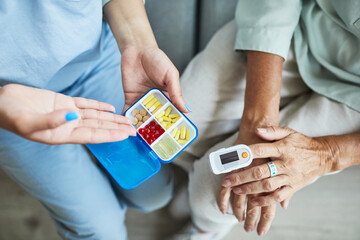 Close up of unrecognizable nurse consulting senior woman in retirement home, copy space