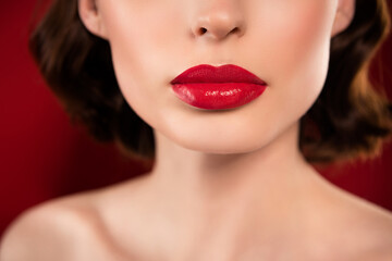Tender cropped photo of female model lips wear red lipstick flawless skin face isolated on burgundy color background