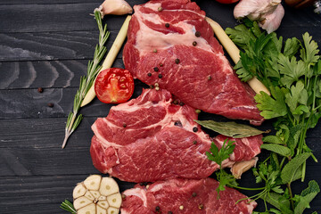 meat on wooden board vegetables and ingredients for cooking wooden background
